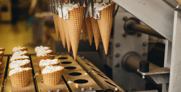 Vanilla ice cream inside cones Vanilla ice cream inside cones which are attached to a machine